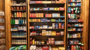 A store with shelves stocked with various food items, including snacks, cereals, and beverages.