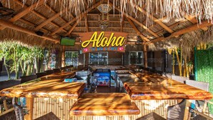 A tiki bar with a thatched roof and wooden bar counters. - Westgate Cocoa Beach Resort (Cocoa Beach)