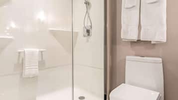 A modern bathroom with a glass-enclosed shower, a white toilet, and a towel rack.