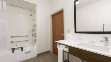 A modern bathroom with a shower, toilet, and sink.