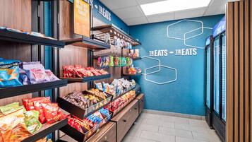 A snack display area with various packaged snacks and a sign reading 'We've got what you forgot.'