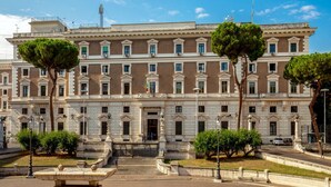 A large, historic building with a symmetrical facade, multiple windows, and a central entrance with steps leading up to it. - Hotel Dorica (Rome)