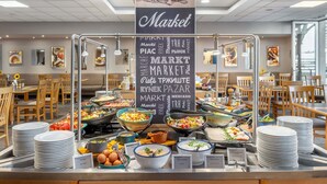 A buffet area with a variety of dishes and a sign reading "Market". - Novotel Szeged (Szeged)