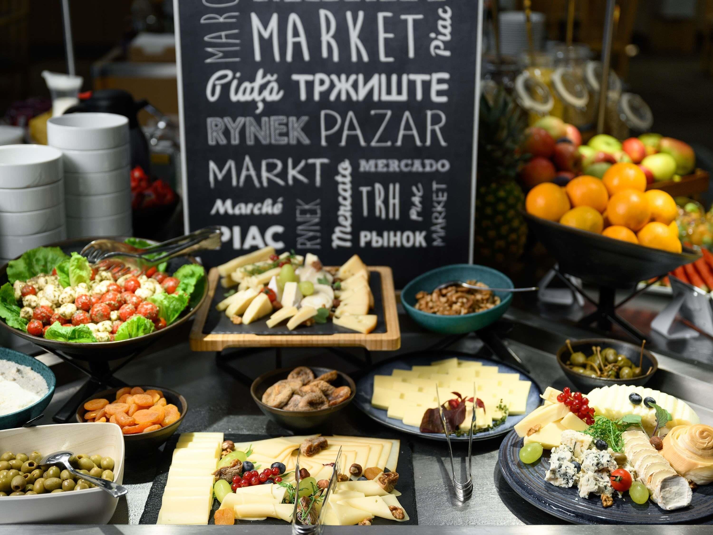 A variety of food items and a sign with multiple language translations.