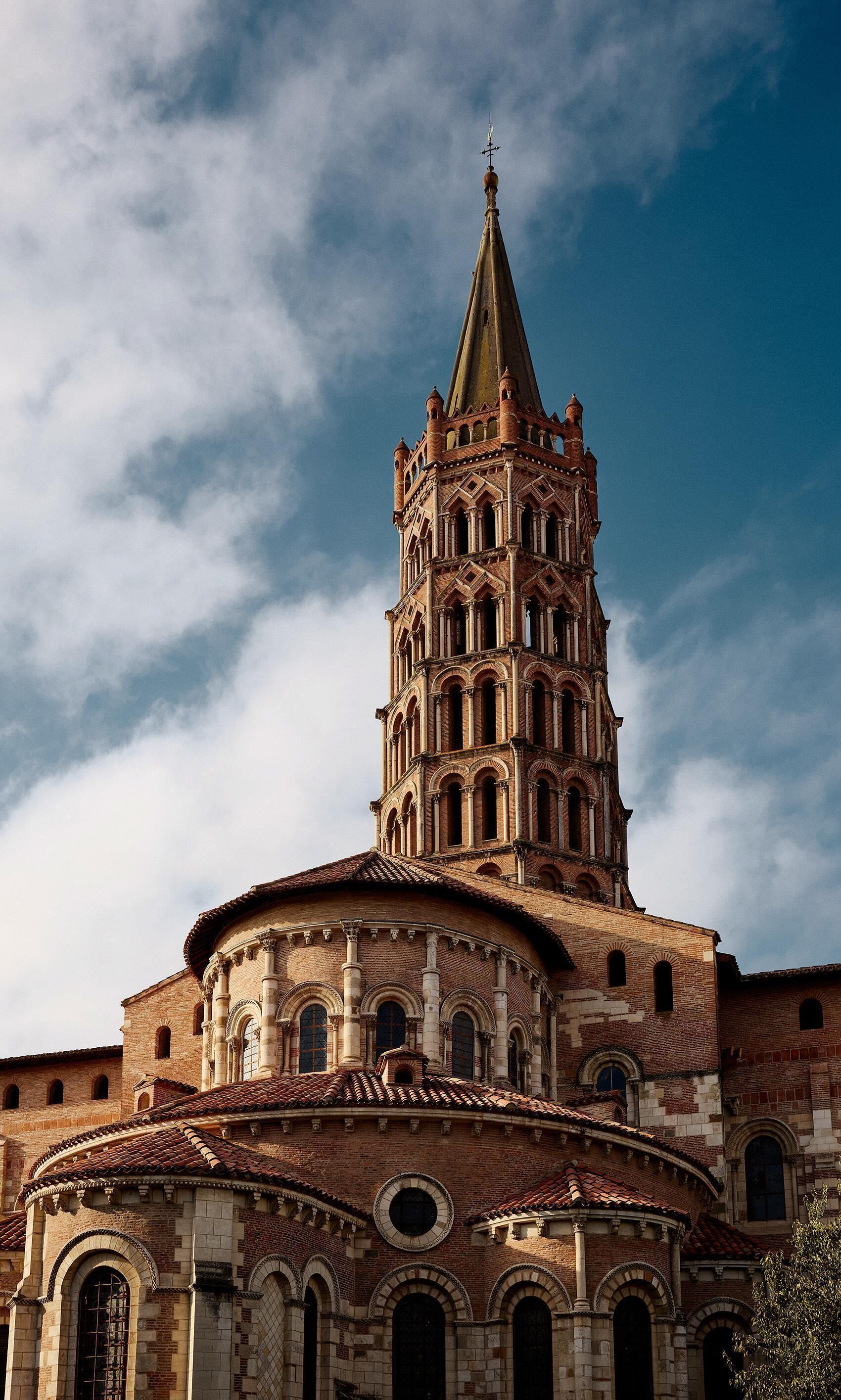 A historic building with a prominent tower and arched windows.