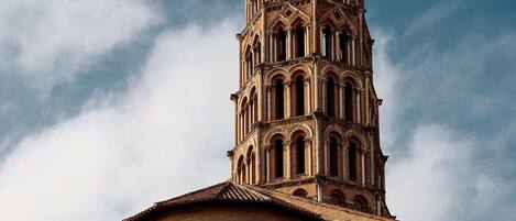 A historic building with a prominent tower and arched windows.