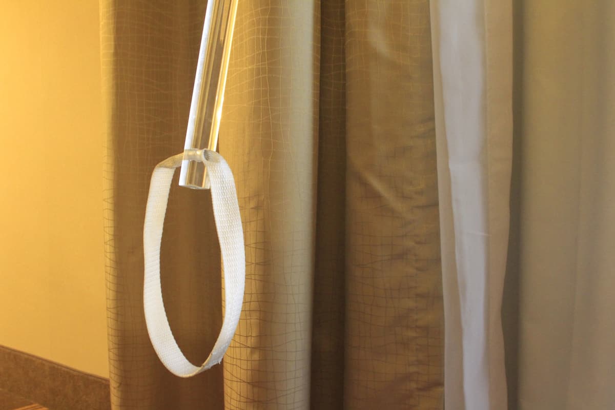 A curtain with a white looped handle.