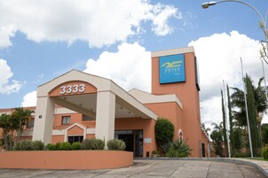 Entrada de un hotel con un letrero que dice "3333" y "FENIX Hotel".