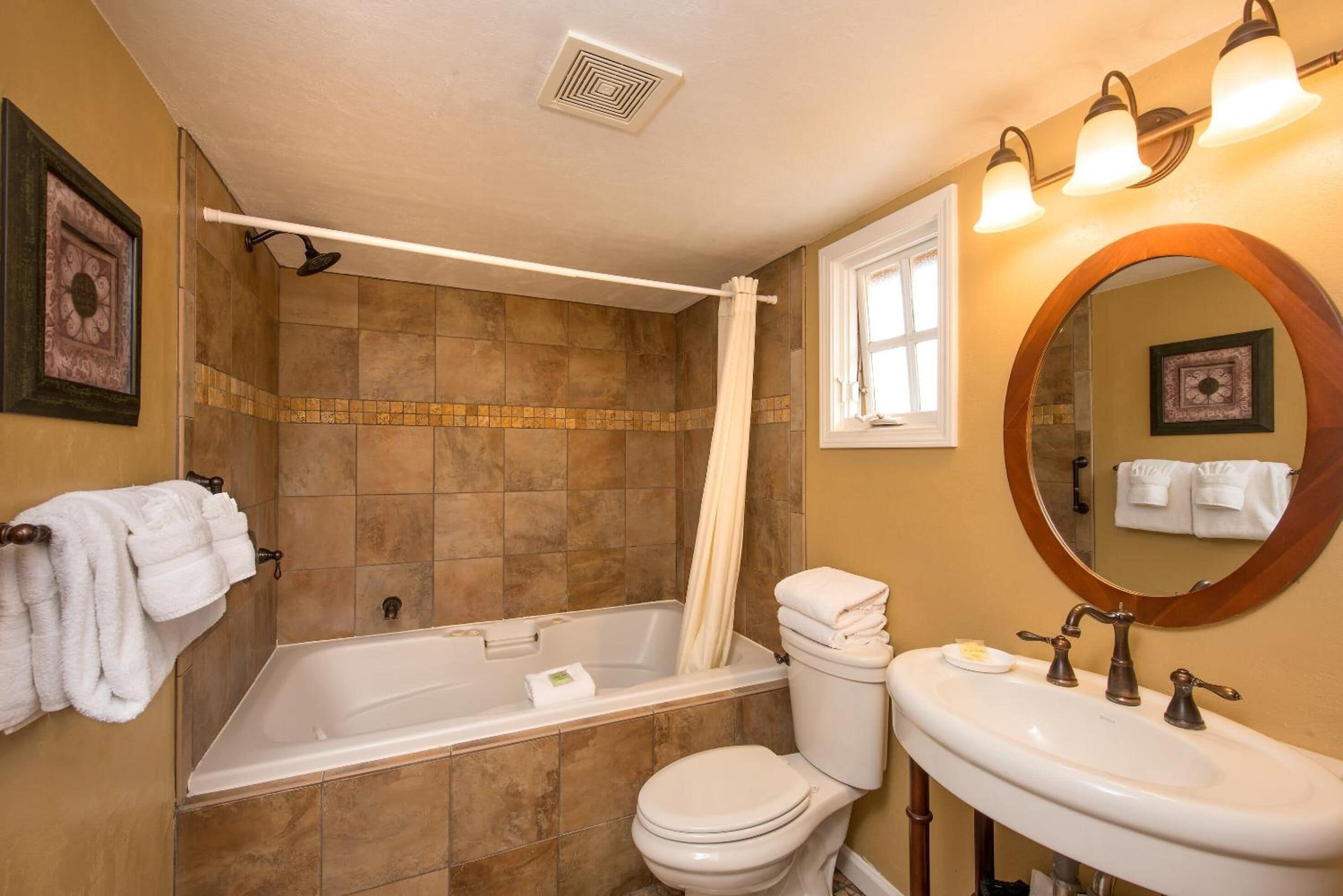 deluxe room, 1 queen bed, jetted tub | bathroom | designer toiletries, hair dryer, towels