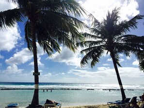 On the beach, white sand, sun loungers, beach towels