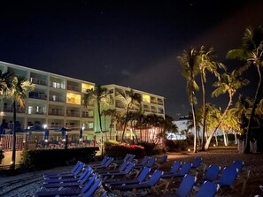 On the beach, white sand, sun loungers, beach towels