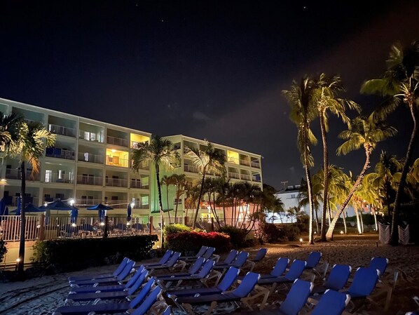 On the beach, white sand, sun loungers, beach towels