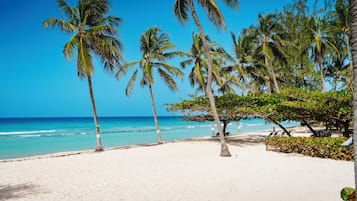 On the beach, white sand, sun loungers, beach towels