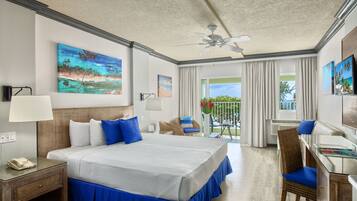 A hotel room with a bed, a desk, a chair, and a balcony with a view.