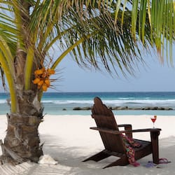 On the beach, white sand, sun loungers, beach towels