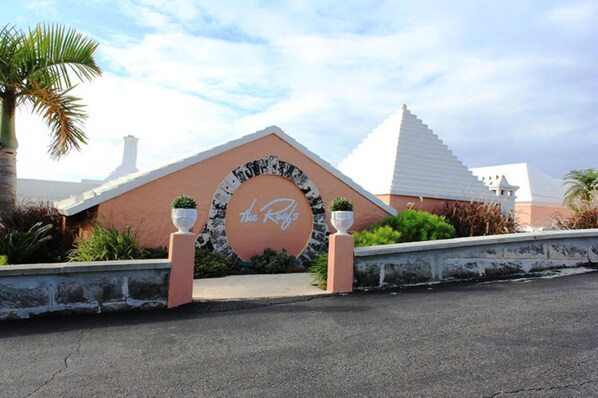 A building with a distinctive arched entrance and a sign that reads "The Reef."