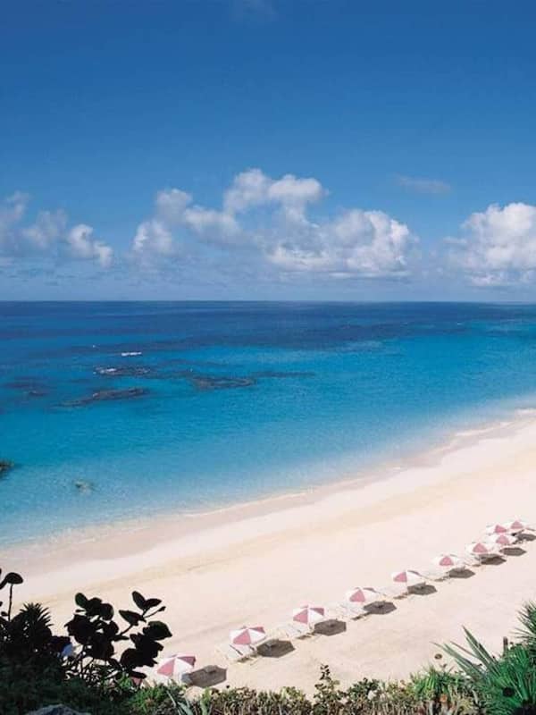 On the beach, white sand, sun loungers, beach umbrellas