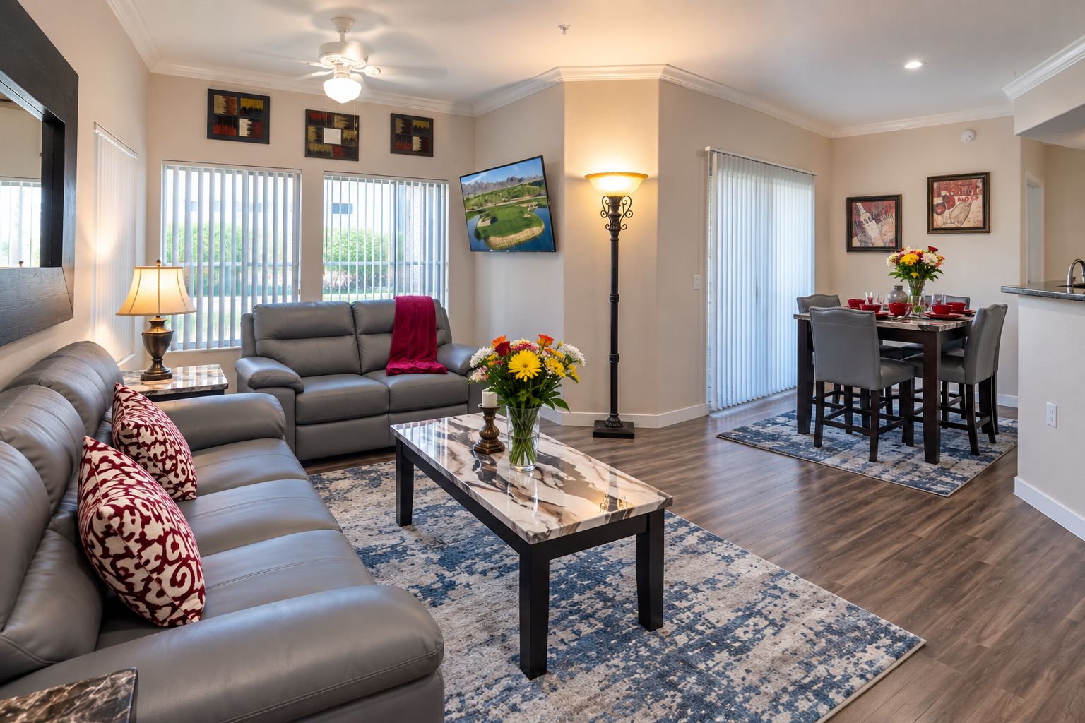 A modern living room with a sofa, coffee table, and dining area.