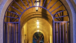 An arched entrance with a lantern, two vases, and a tiled floor. - Meridian CondoResorts (Scottsdale)