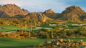 A desert golf course with rocky terrain, cacti, and a clear sky. - Meridian CondoResorts (Scottsdale)