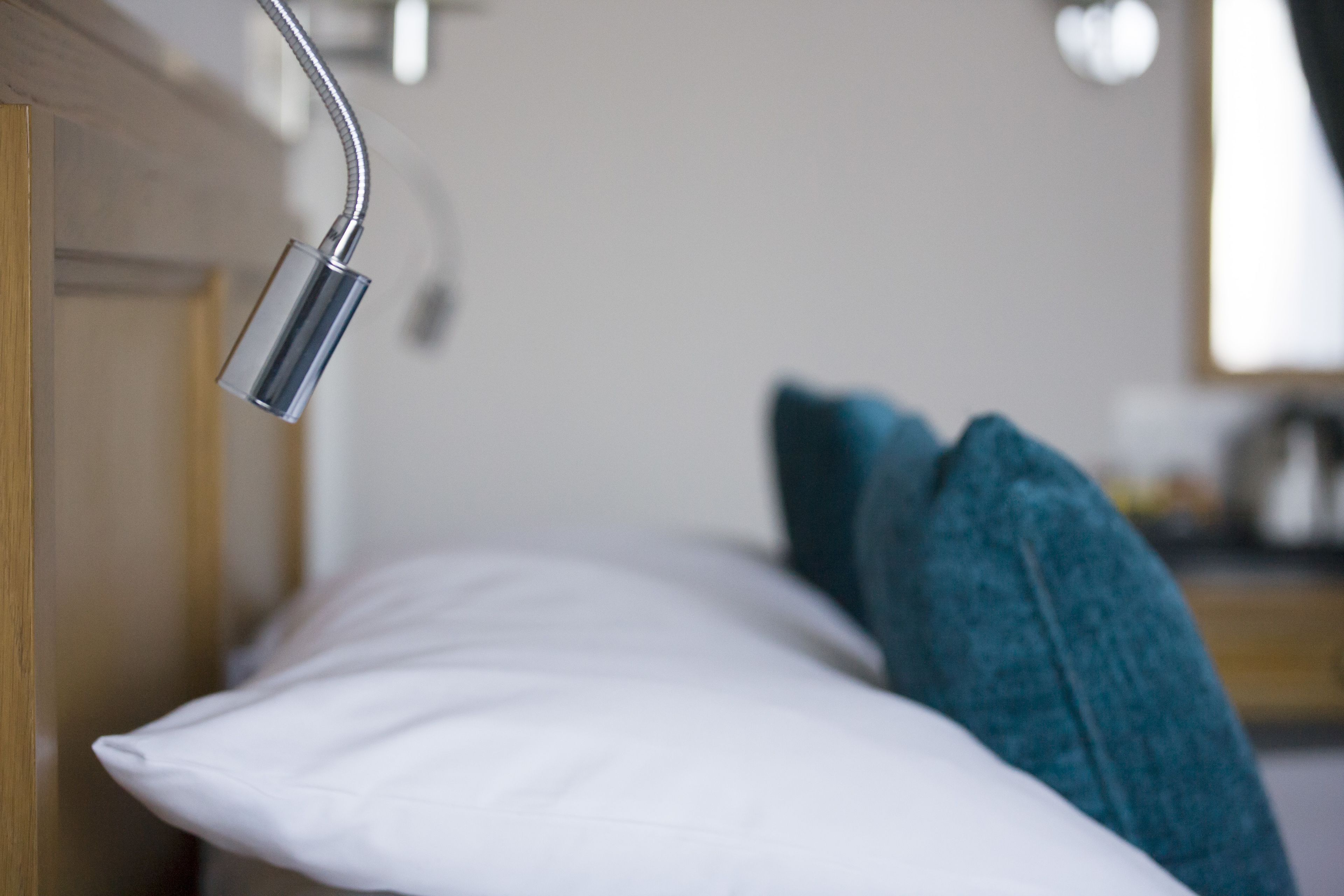 A close-up of a showerhead in a hotel room.