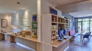 A breakfast bar with a variety of food items and a coffee station. - Holiday Inn Express Dortmund by IHG (Dortmund)