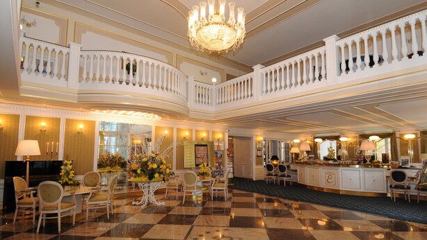 A grand lobby with a checkered floor, a chandelier, and a bar area. - Esplanade Spa and Golf Resort (Marianske Lazne)