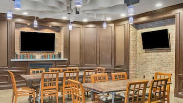 A restaurant with brick walls, wooden paneling, and multiple tables and chairs.