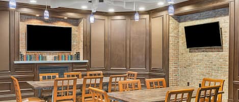 A restaurant with brick walls, wooden paneling, and multiple tables and chairs.