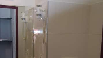 A bathroom with a sink, mirror, and toilet.
