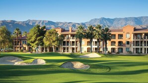A golf course with a building in the background.