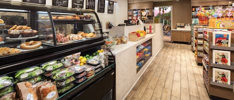 A bakery display with various baked goods and a deli section with sandwiches and salads.