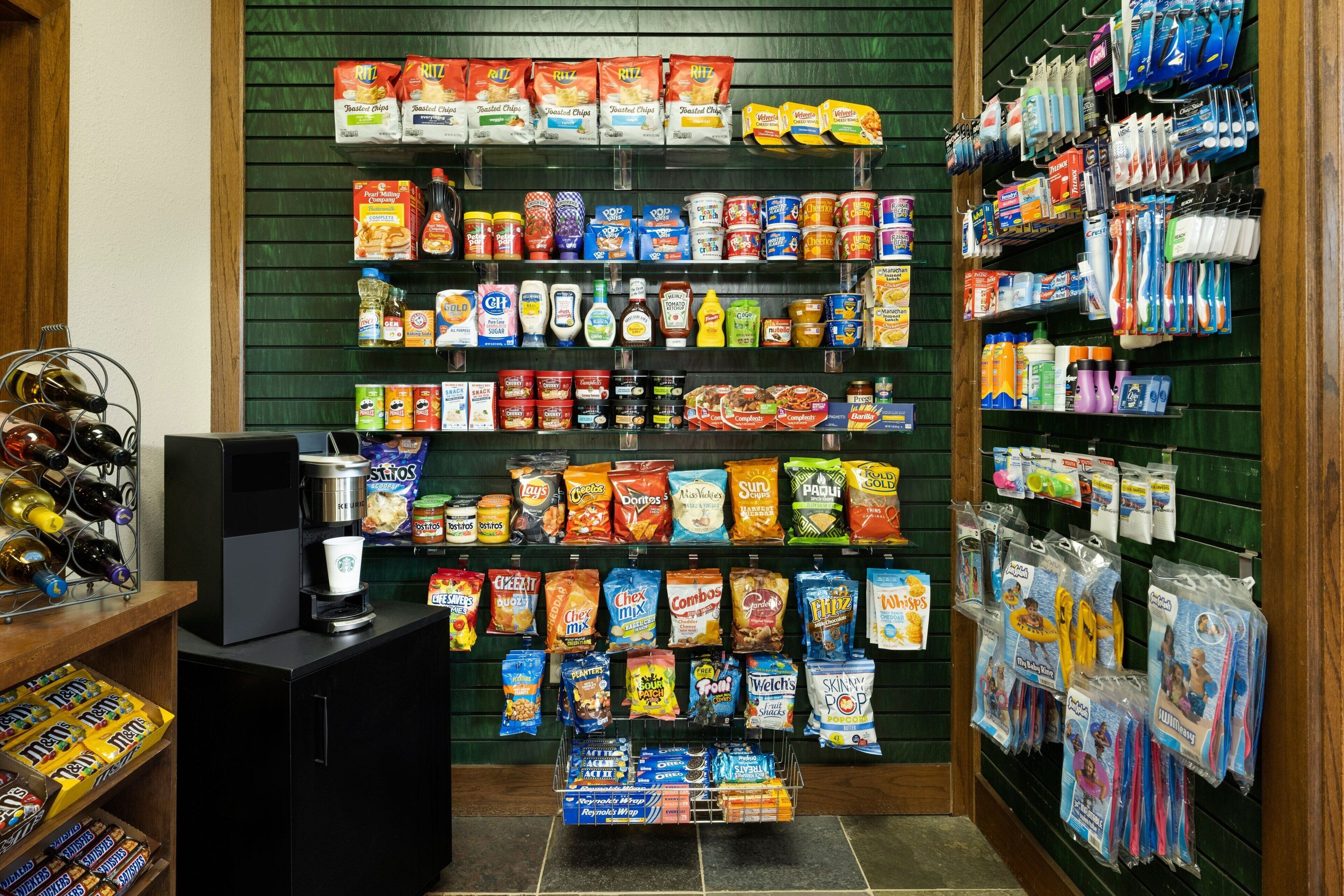 A grocery store aisle with various snack and household items.