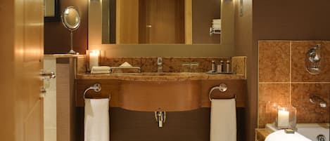 A modern bathroom with a wooden vanity, dual sinks, and a large mirror.