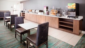 A breakfast area with seating, a coffee machine, and food display. - Residence Inn By Marriott Dallas Park Central (Dallas)