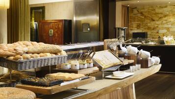 Ein reichhaltiges Buffet mit verschiedenen Brotsorten, Gebäck und Aufstrichen.