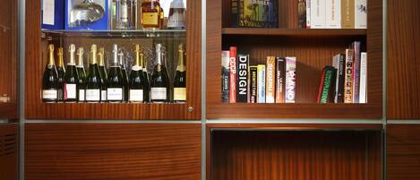 A modern interior with a wooden bookshelf, a yellow armchair, and a round table.