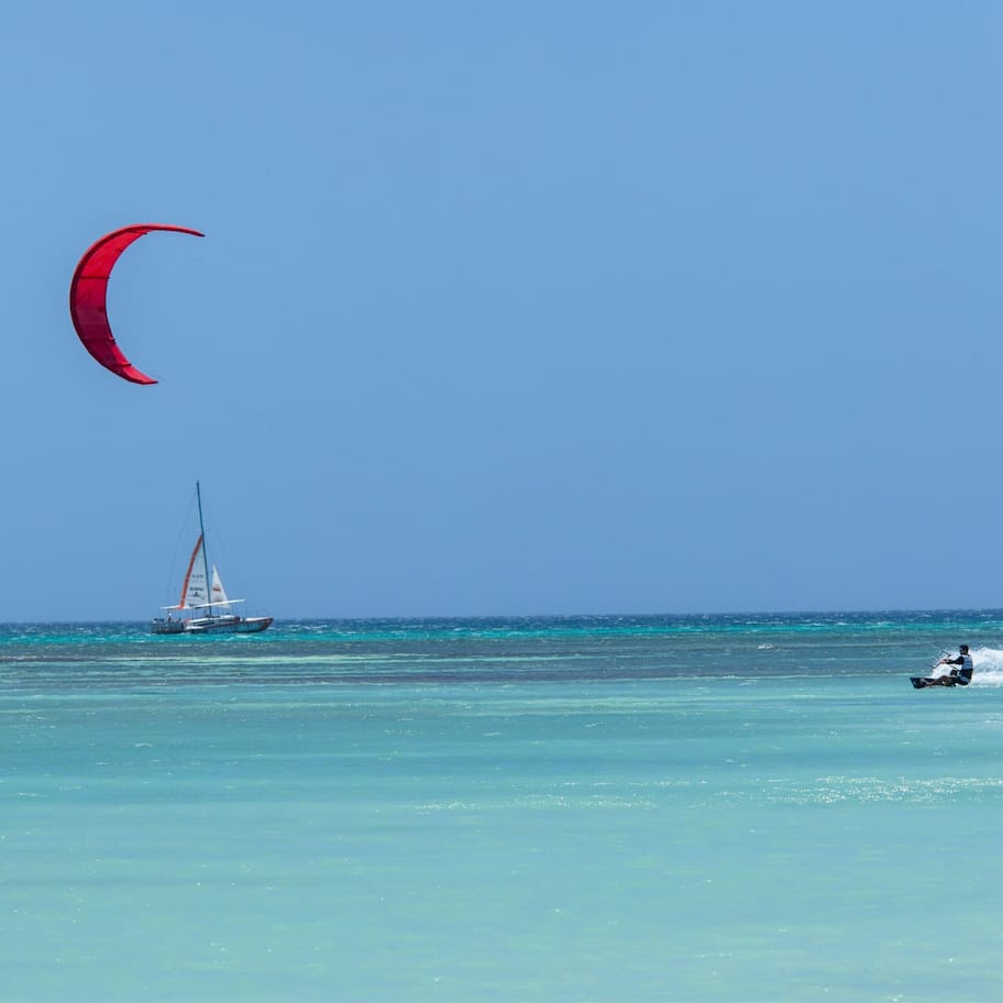 On the beach, white sand, beach cabanas, sun loungers
