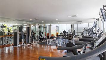 A gym with various exercise equipment, including treadmills and weight machines.