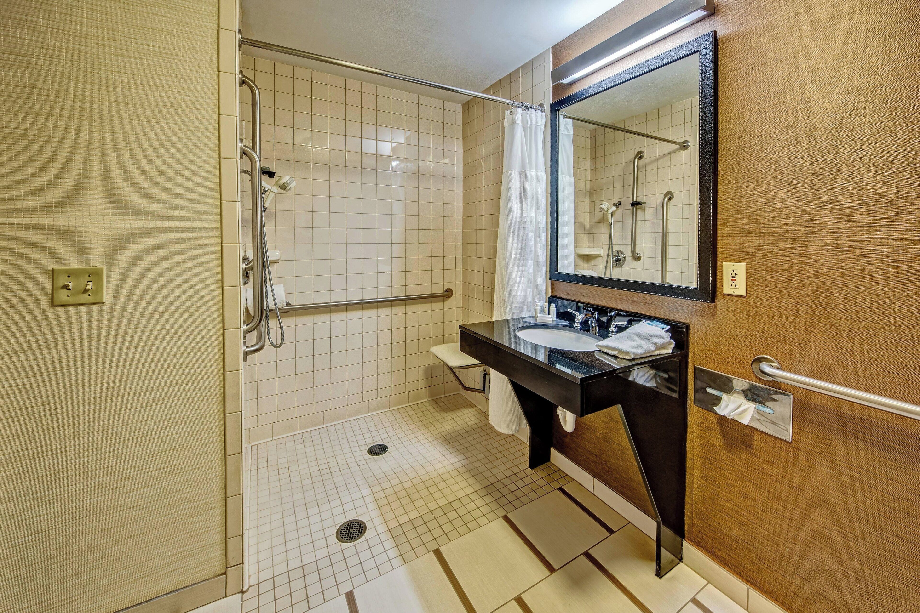 room, 1 king bed (mobility/hearing access, roll-in shwr) | bathroom | combined shower/bathtub, hair dryer, towels, soap
