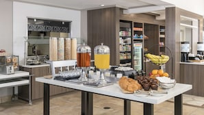 A breakfast buffet with various food items and beverages.