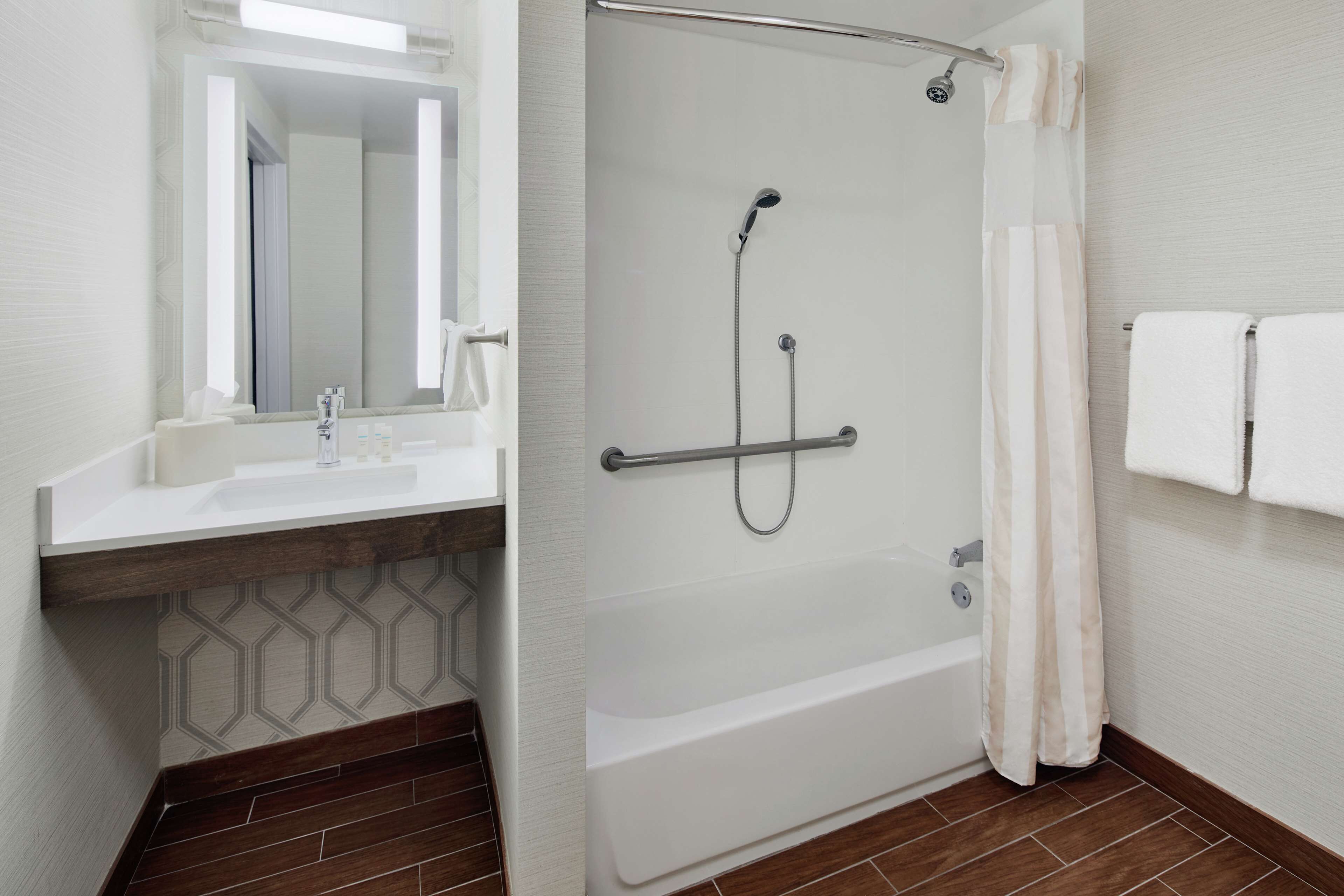 combined shower/bathtub, designer toiletries, hair dryer, towels