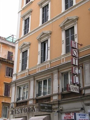 A hotel with a classic facade, featuring a prominent 'HOTEL' sign and a 'RISTORANTE DA NAZZARENO' sign below. - Hotel Rimini (Rome)
