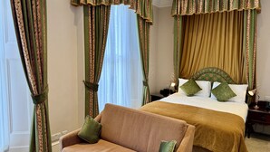 A hotel room with a bed, a sofa, and curtains. - The Windermere Hotel, London (London)