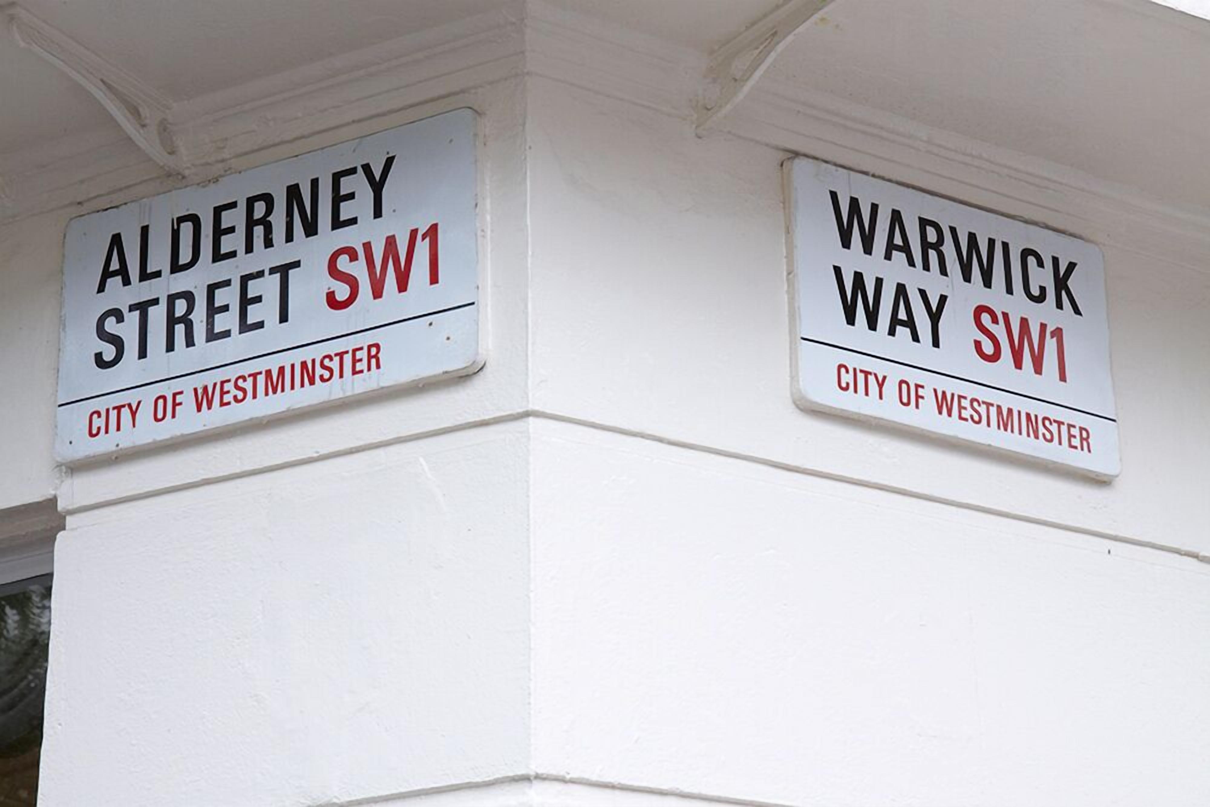Two street signs for Alderney Street and Warwick Way SW1 in the City of Westminster.
