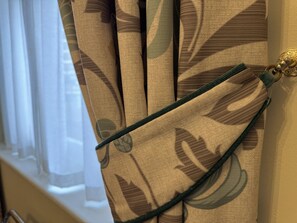 A window with sheer white curtains and a view of a building outside. - The Windermere Hotel, London (London)