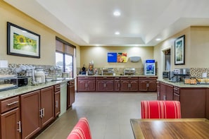 A modern kitchen with granite countertops, stainless steel appliances, and a breakfast bar.