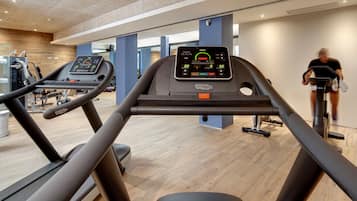 A gym with treadmills and exercise equipment.