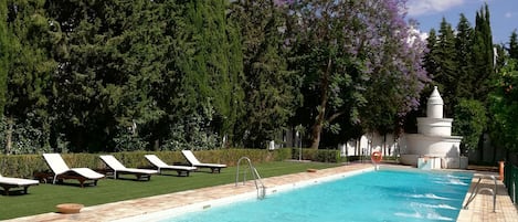 Seasonal outdoor pool, open 9:30 AM to 8:30 PM, pool loungers