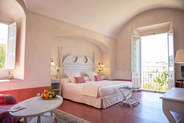 Relax in this stylish room with a large bed, balcony, and city view.
